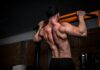 근육, 더 이상 운동선수만의 전유물 아니다…일상 속 근육 관리법 주목 topless man in black shorts holding orange bar
